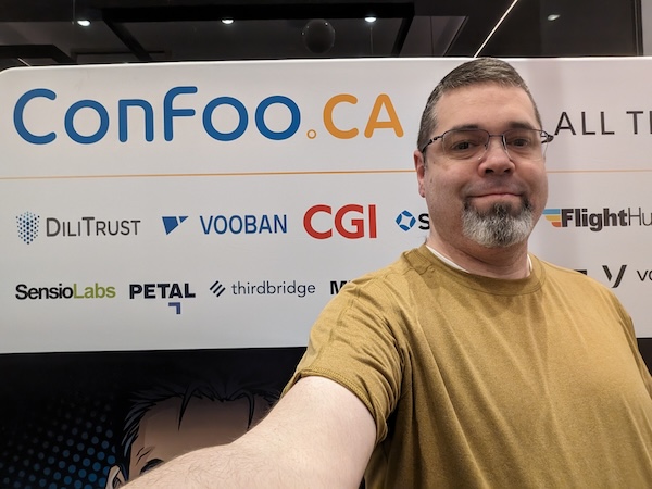 Me in front of ConFoo 2024 Banner